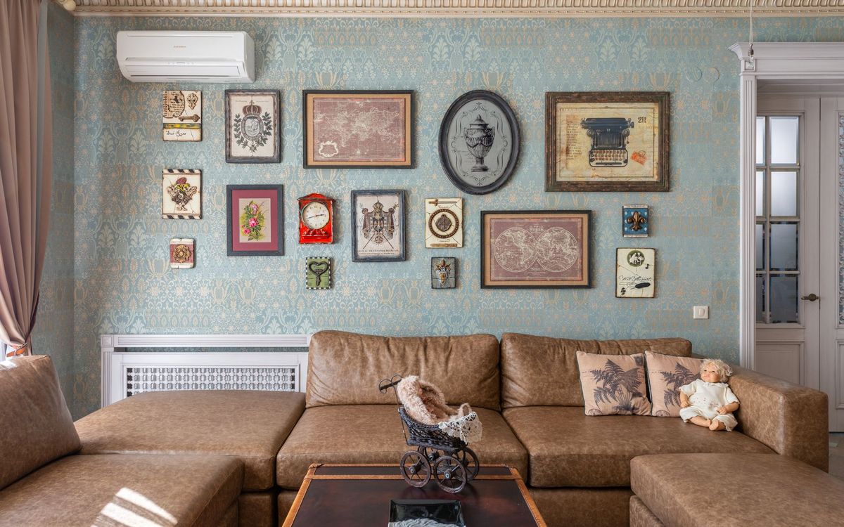 Living room with a sofa and framed pictures hung on the wall above it